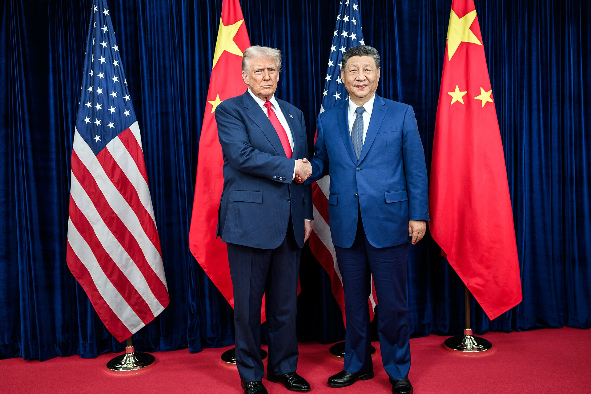 President Donald Trump greets Chinese President Xi Jinping before a bilateral meeting at the Gimhae International Airport terminal in Busan, South Korea.