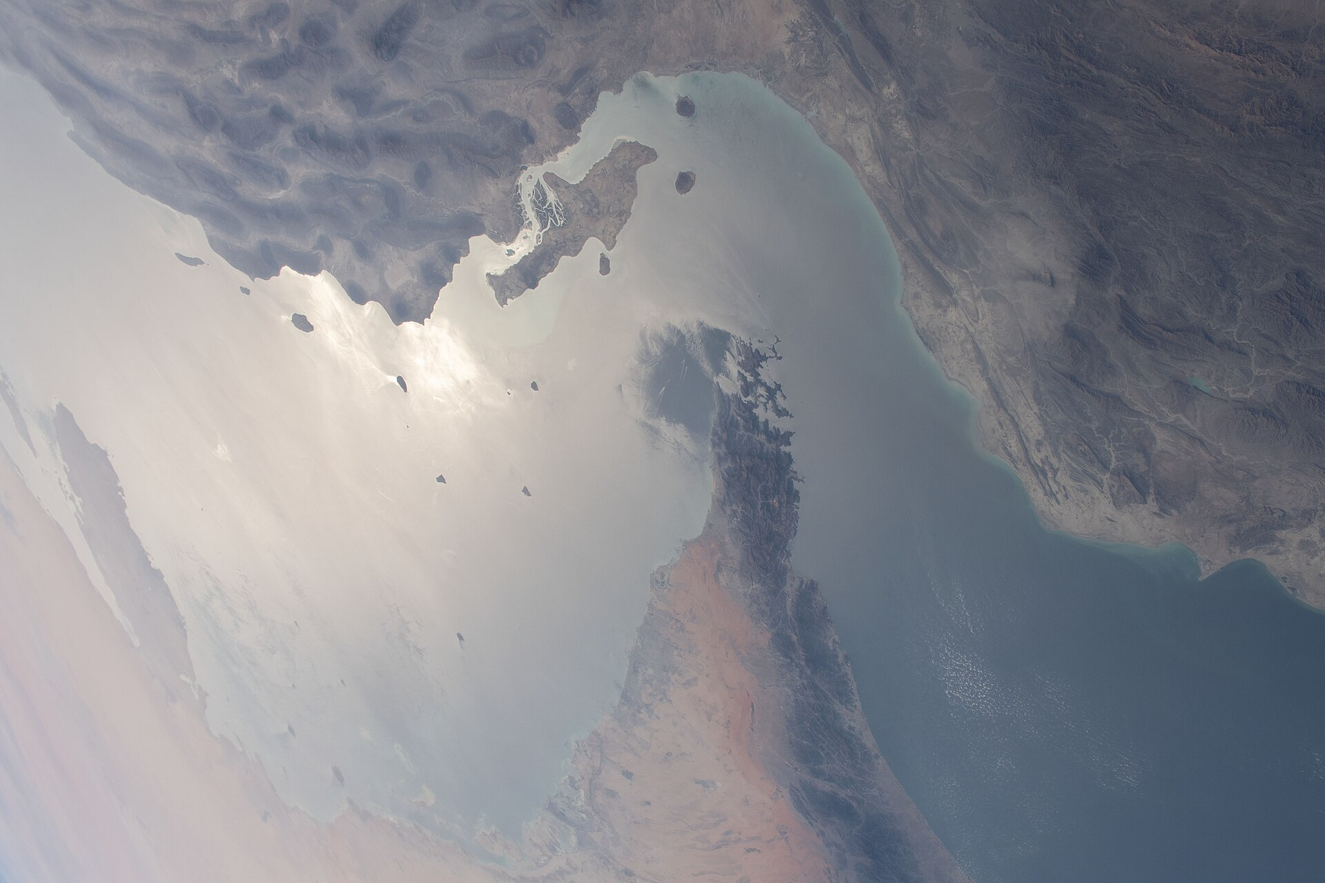 The Strait of Hormuz, separating the United Arab Emirates and Iran, and connecting the Persian Gulf to the Gulf of Oman, photographed from the International Space Station.