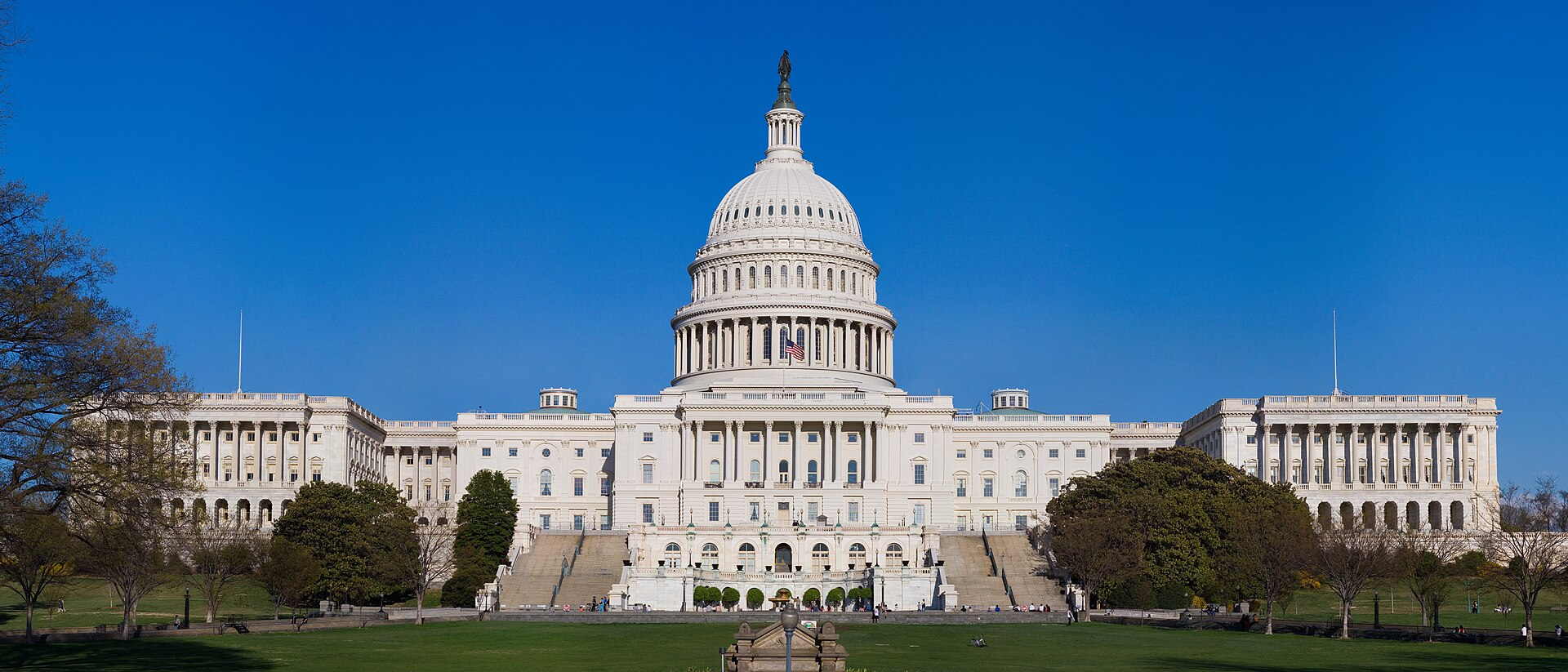 The western front of the United States Capitol building, with its central dome, rotunda, and two wings.